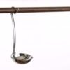 Polished stainless steel ladle hanging on a wooden kitchen rail. Shiny metal soup spoon utensil isolated on white background. Copy space Stainless Steel Soup Ladle